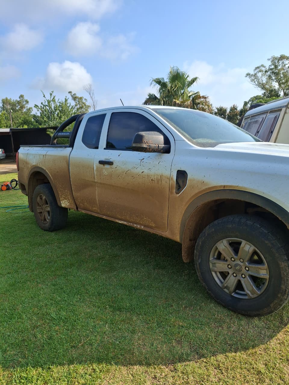 Silver Ford Ranger covered in mud, before its detail